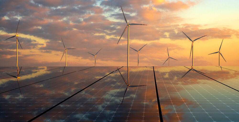 Solar Panels Reflecting the Sky and Wind Turbines in the Background